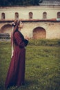 Portrait of brunette woman praying, dressed in historical Baroque clothes, outdoors Royalty Free Stock Photo