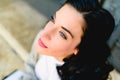 Portrait of brunette woman with thoughtful face, 30s, standing at the city in winter looking away, thinking Royalty Free Stock Photo