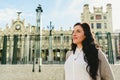 Portrait of brunette woman with thoughtful face, 30s, standing at the city in winter looking away, thinking Royalty Free Stock Photo