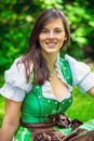 Portrait of brunette young woman wearing a bavarian dirndl Royalty Free Stock Photo