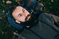 Portrait brutal bearded hipster dreamer man in the forest