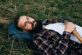 Portrait brutal bearded hipster man in the forest with ax