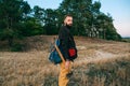 Portrait brutal bearded hipster man in the forest with ax