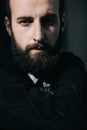 Portrait of a brutal bearded man on dark street background