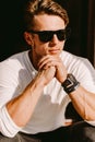 Portrait of a brutal man in sunglasses and watch outdoors Royalty Free Stock Photo