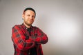 Portrait of a brutal successful builder, on a light background. average plan of a man in a plaid work shirt Royalty Free Stock Photo