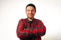 Portrait of a brutal successful builder, on a light background. average plan of a man in a plaid work shirt Royalty Free Stock Photo
