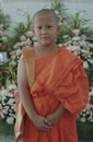 portrait of buddhist novice wearing thai monk clothes standing outdoor