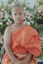 portrait of buddhist novice wearing thai monk clothes standing outdoor