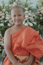 portrait of buddhist novice wearing thai monk clothes standing outdoor