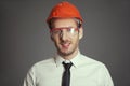 Portrait of a Builder in orange helmet and goggles