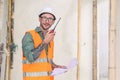 portrait builder professional engineer architect foreman hipster worker work in construction site, talk radio operation