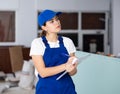 Portrait of builder woman who checks completed work on