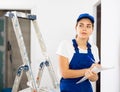 Portrait of builder woman who checks completed work on