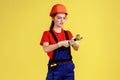 Builder woman working with adjustable wrench, looking with serious concentrated expression.