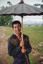 Portrait of burmese man with traditional umbrella