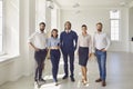 Portrait of business coaches with office workers looking at camera in business center office. Royalty Free Stock Photo