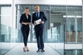 Portrait of business colleagues standing with digital tablet in corridor Royalty Free Stock Photo