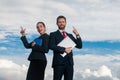Portrait of a business couple with pointing finger. Young confident businesspeople. Secretary and boss. Business people