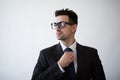 Portrait of a business man adjusting his tie on a white background. Royalty Free Stock Photo