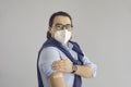 Businessman or office worker in face mask showing arm after getting Covid 19 shot