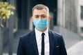 Portrait Business Man in Protective Face Mask Look at Camera COVID-19 Coronavirus Infection. Face mask Covid-19