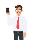 Portrait of business man showing a new brand, latest smartphone screen. Young man holding cell or mobile phone in hand. Royalty Free Stock Photo