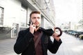 Portrait of a business man walking around the city with an umbrella in his hand and talking on the phone Royalty Free Stock Photo