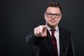 Portrait of business man wearing black suit pointing camera Royalty Free Stock Photo