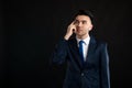 Portrait of business man wearing blue business suit and tie making thinking gesture Royalty Free Stock Photo