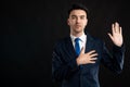 Portrait of business man wearing blue business suit and tie taking oath gesture Royalty Free Stock Photo