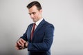 Portrait of business man wearing suit checking wrist watch Royalty Free Stock Photo