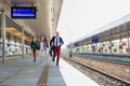 Portrait of business people running to catch the train in station Royalty Free Stock Photo