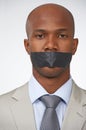 Portrait, business and tape with black man, mouth covered and employee on white studio background. Face, African person Royalty Free Stock Photo