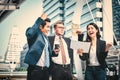 Portrait of Business team raising arms celebrate on blurred city background. Business success concept