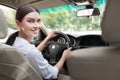 Portrait of business woman in car, looking on camera Royalty Free Stock Photo