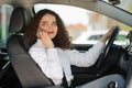 Portrait of business woman driver talking her mobile phone while driving car Royalty Free Stock Photo