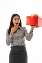 Portrait of business woman looking to the gift.Asian young lady holding beautiful red present box with surprise facial expression Royalty Free Stock Photo
