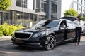 Portrait of business woman near a luxury car outdoors