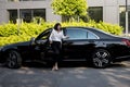 Portrait of business woman near a luxury car outdoors Royalty Free Stock Photo