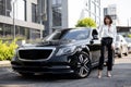 Portrait of business woman near a luxury car outdoors Royalty Free Stock Photo