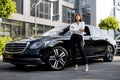 Portrait of business woman near a luxury car outdoors Royalty Free Stock Photo