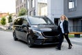 Portrait of business woman near luxury minivan taxi Royalty Free Stock Photo