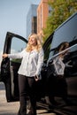 Portrait of business woman near minivan taxi