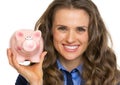 Portrait of business woman showing piggy bank