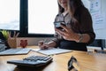 Portrait of business woman and smiling using video call on smartphone with her parents. Quarantine and work from home concept Royalty Free Stock Photo