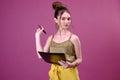 Portrait of business woman or student with pen and paper folder. Young pretty worker writing something in her papers Royalty Free Stock Photo