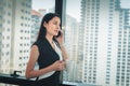 Portrait of Business Woman is Talking on Mobile Phone in Office Workplace, Attractive Beautiful Businesswoman is Talking on Royalty Free Stock Photo