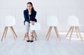 Portrait business woman waiting for an interview or stress applicant sitting alone. Sad or nervous corporate