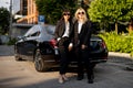 Portrait of business women near a luxury car outdoors Royalty Free Stock Photo